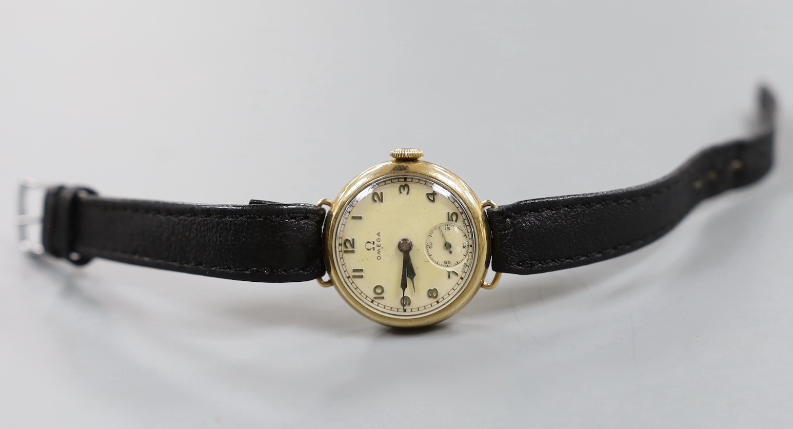 A lady's 9ct gold Omega manual wind wrist watch, a 935 white metal fob watch with albert and a silver open faced pocket watch.